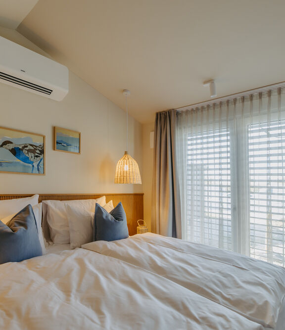 Doppelbett in einem Guesthouse am Neuen Strand Neusiedler See